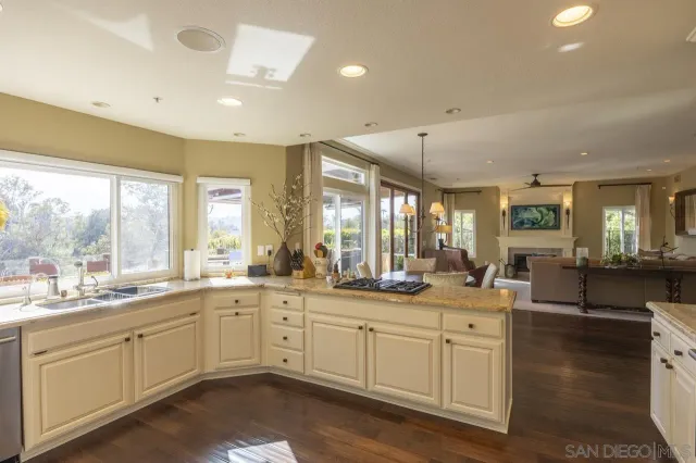 a large white kitchen with a large window