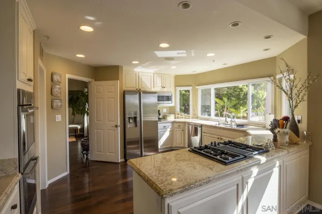 a kitchen with a stove a refrigerator and a sink