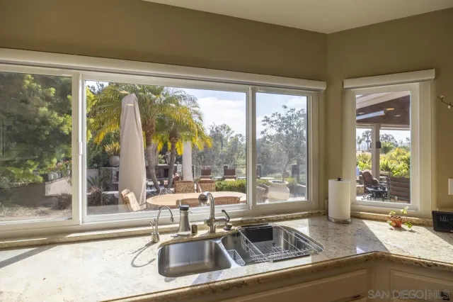 a view of a sink and room with a large window