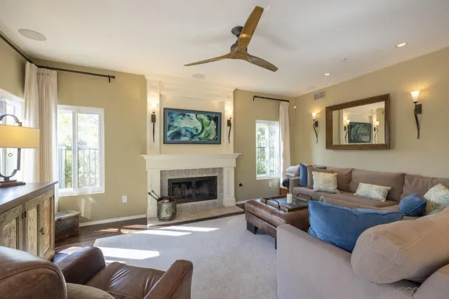 a living room with furniture and a fireplace