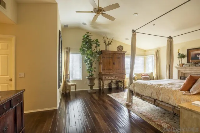 a view of a hallway with wooden floor and furniture
