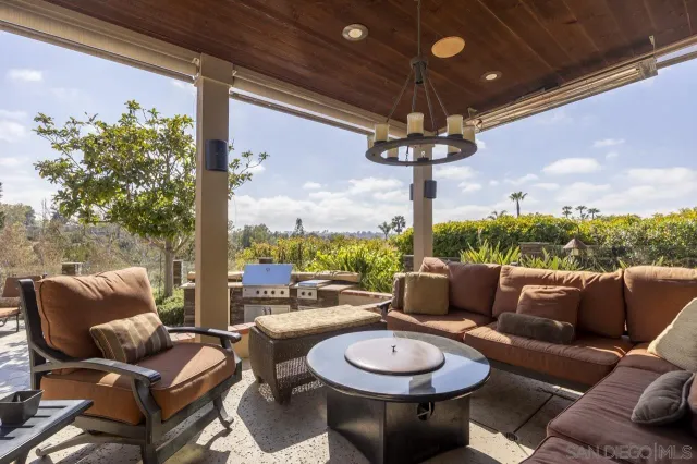 a outdoor space with patio couches and a large tree