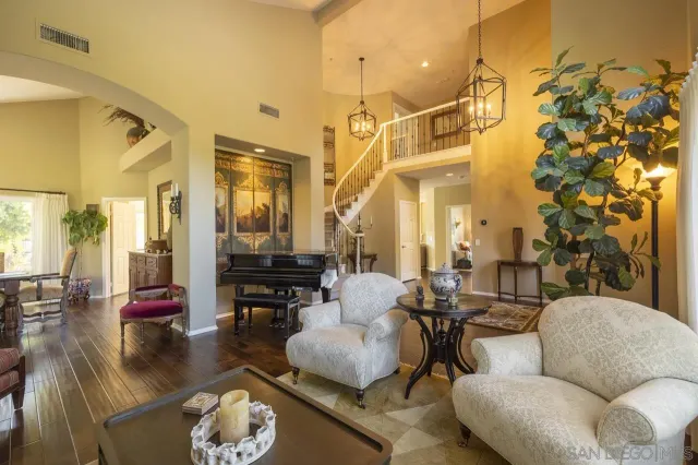 a living room with furniture and a chandelier