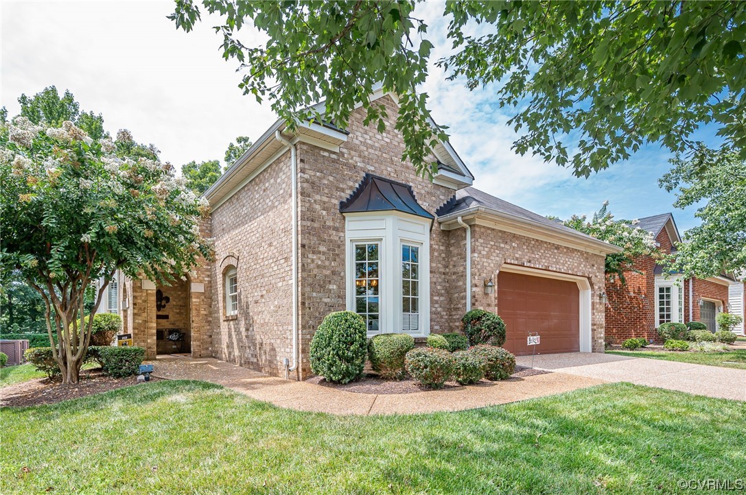 front view of a house with a yard and an trees