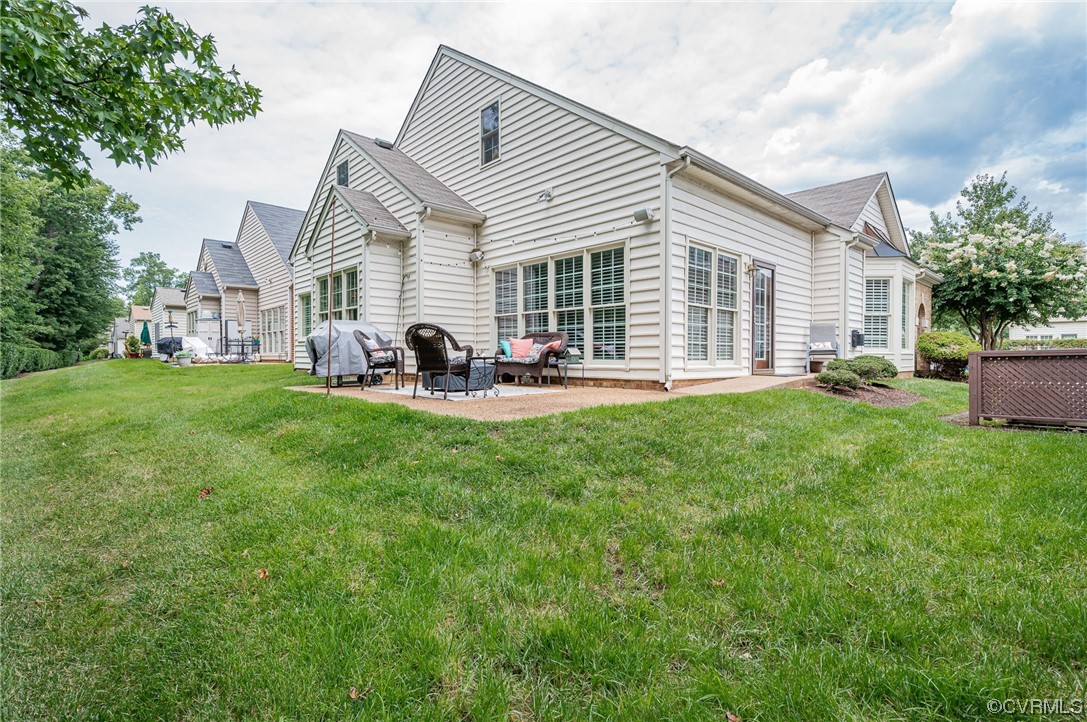 5080 Park Commons Loop Glen Allen, VA 23059 - Photo 40 of 41 a front view of house with a garden and patio