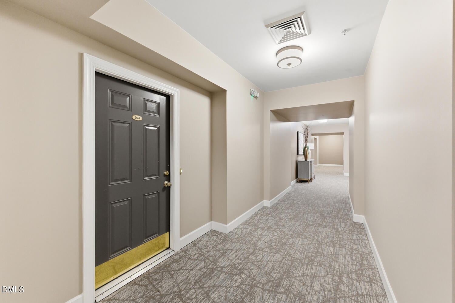 116 Northbrook Drive, Unit 204 Raleigh, NC 27609 - Photo 58 of 94 a view of a hallway with a chandelier