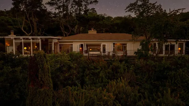 a view of a dining room with furniture and a chandelier