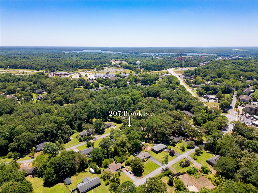 207 Brook Street Clemson, SC 29631 - Photo 34 of 39 An aerial perspective reveals the tranquil neighborhood in Clemson surrounded by lush woodlands and distant water views.