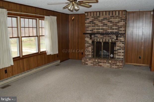 6485 Bent Pine Road Willards, MD 21874 - Photo 3 of 15 a view of an empty room with a fireplace and a window