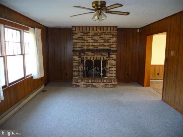 6485 Bent Pine Road Willards, MD 21874 - Photo 4 of 15 a view of an empty room with a fireplace and a window