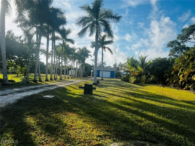 a swimming pool with outdoor seating and yard