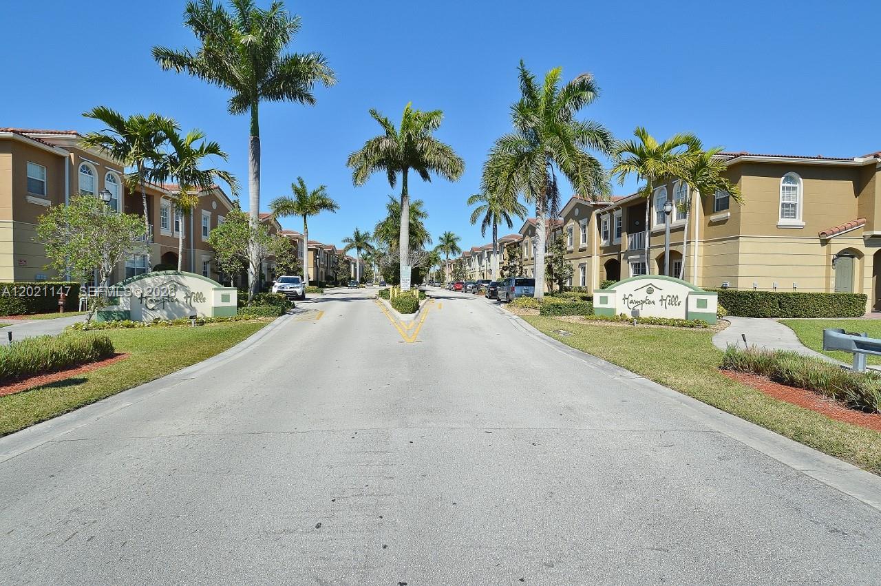 5930 Abbey Road Tamarac, FL 33321 - Photo 17 of 26 a row of palm trees in front of a house