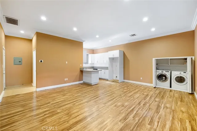 a view of a kitchen with a sink and a refrigerator