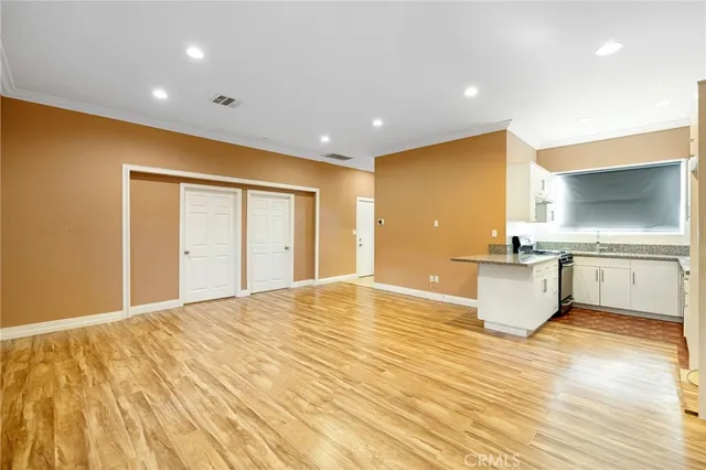 a large kitchen with granite countertop a sink and a stove top oven