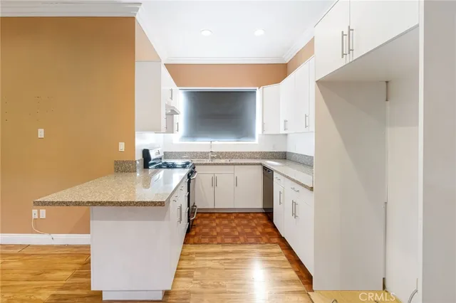 a kitchen with stainless steel appliances granite countertop a sink and a stove with granite countertops