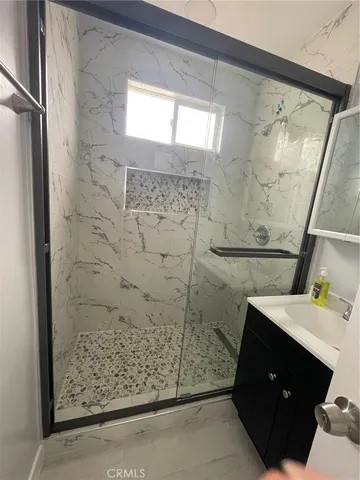 a bathroom with a shower and a sink