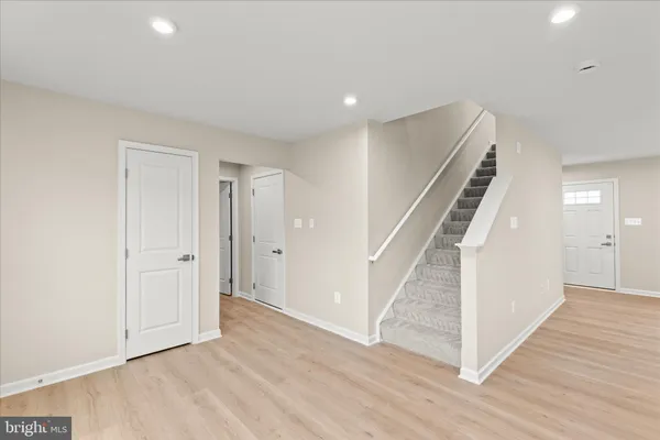 a view of entryway with wooden floor and stairs