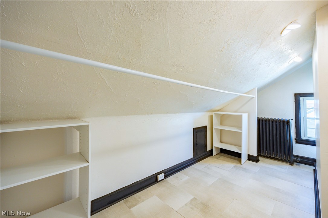 3254 Redwood Road Cleveland Heights, OH 44118 - Photo 28 of 49 Bonus room featuring a textured ceiling, vaulted ceiling, and radiator