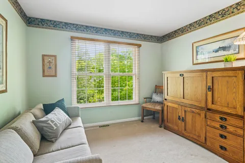 a living room with furniture and large window