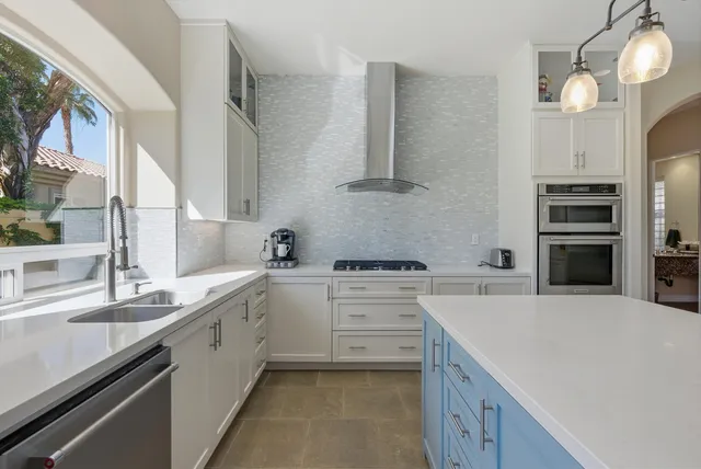 a kitchen with a sink stove and refrigerator