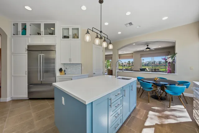 a kitchen with a sink a counter top space and appliances