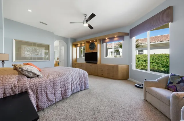 a bedroom with bed couch and window