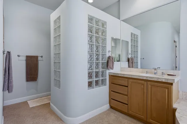 a bathroom with a double vanity sink and mirror