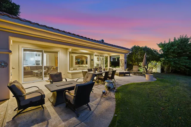 a view of a house with backyard sitting area and garden