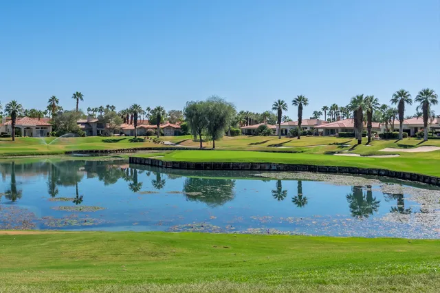 a view of a lake with a house in the background