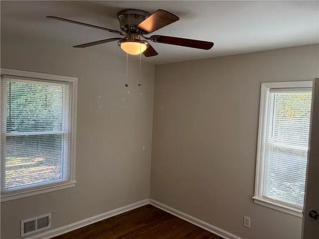 a view of wooden floor and windows in a room