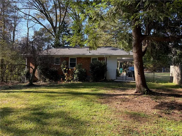 a view of a house with backyard porch and sitting area
