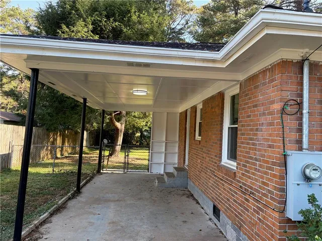a view of a porch with a floor to ceiling window and a yard