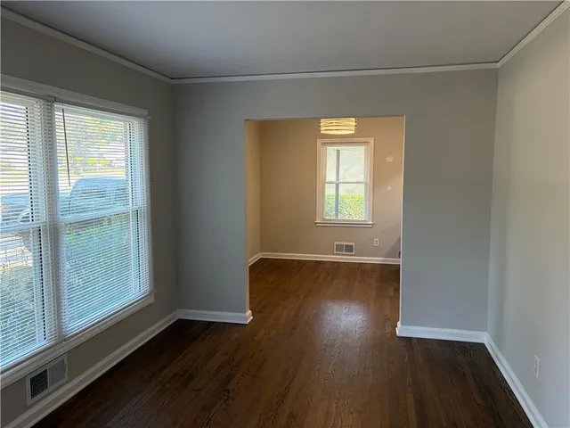 a view of a livingroom with wooden floor and window