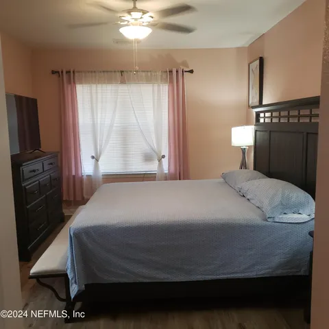 a bedroom with a bed and a night stand