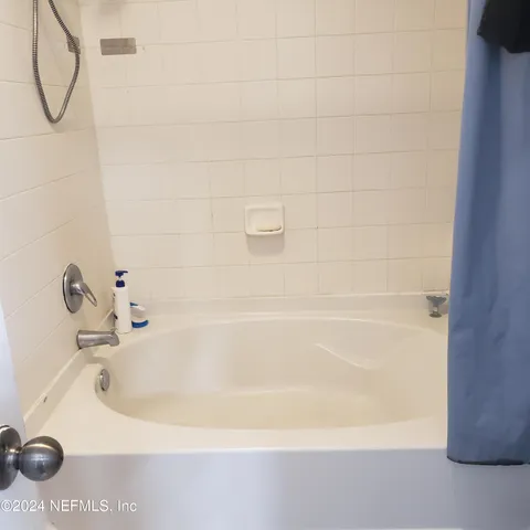 a bedroom with a bed and a lamp