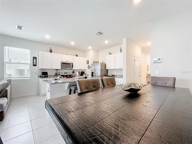 a kitchen with stainless steel appliances kitchen island granite countertop a sink and cabinets