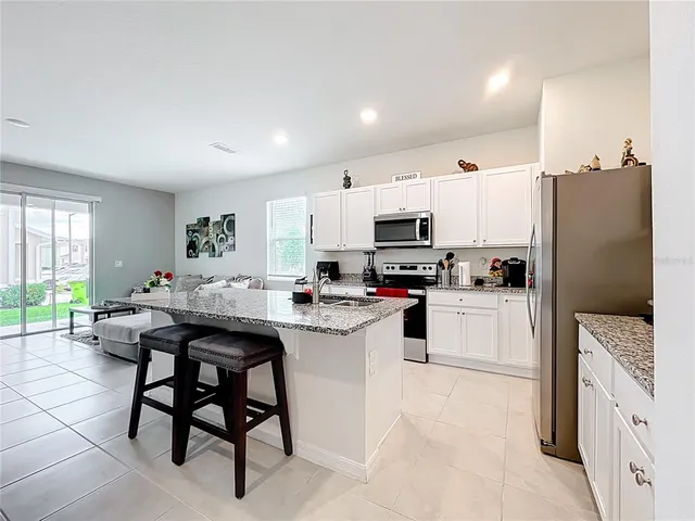 a kitchen with refrigerator and cabinets