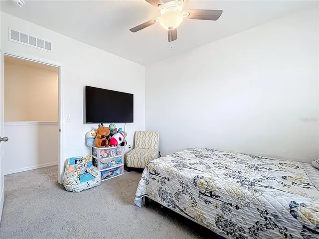 a bedroom with bed and a flat screen tv
