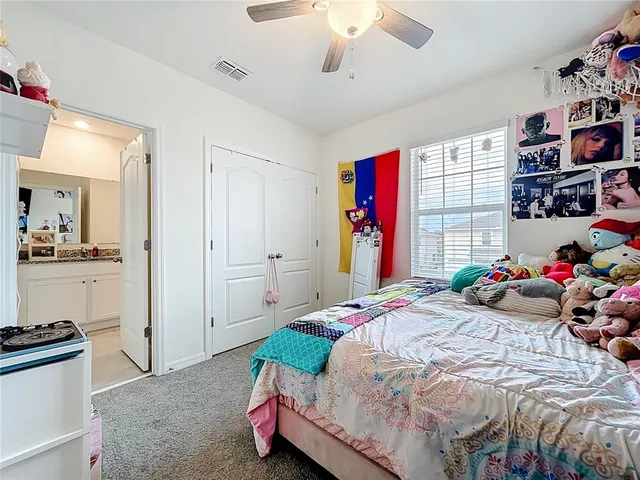a bedroom with bed and a chandelier