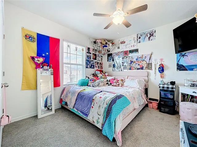 a bedroom with bed and a flat screen tv
