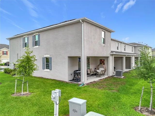 a front view of a house with a yard and trees
