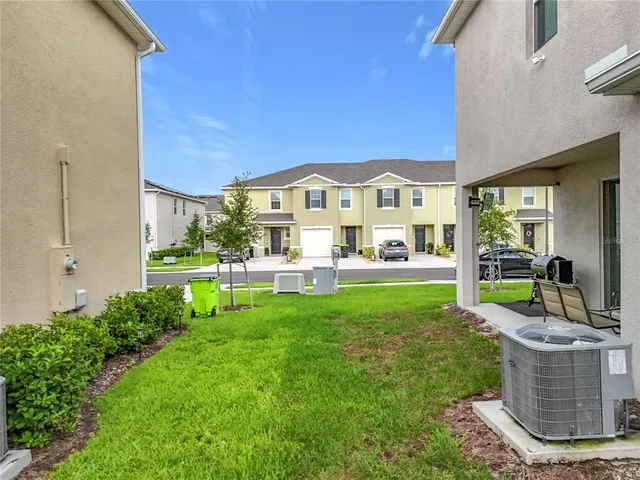 a view of a house with backyard sitting area and garden