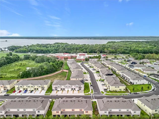an aerial view of residential houses and outdoor space