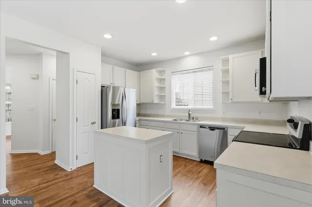 a kitchen with a refrigerator sink and stove