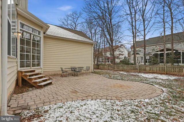a backyard of a house with barbeque oven table and chairs