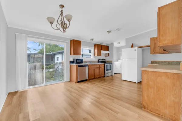 a kitchen with stainless steel appliances granite countertop a refrigerator sink and cabinets