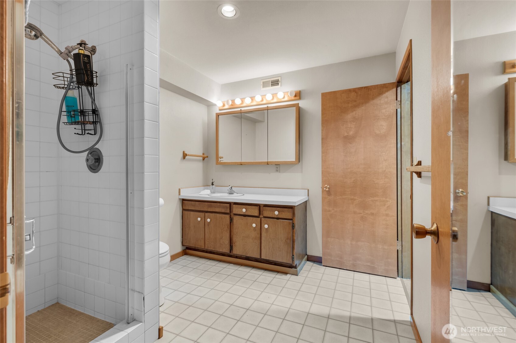 712 Moonlit Lane Wenatchee, WA 98801 - Photo 16 of 29 a bathroom with a granite countertop sink a mirror and a shower