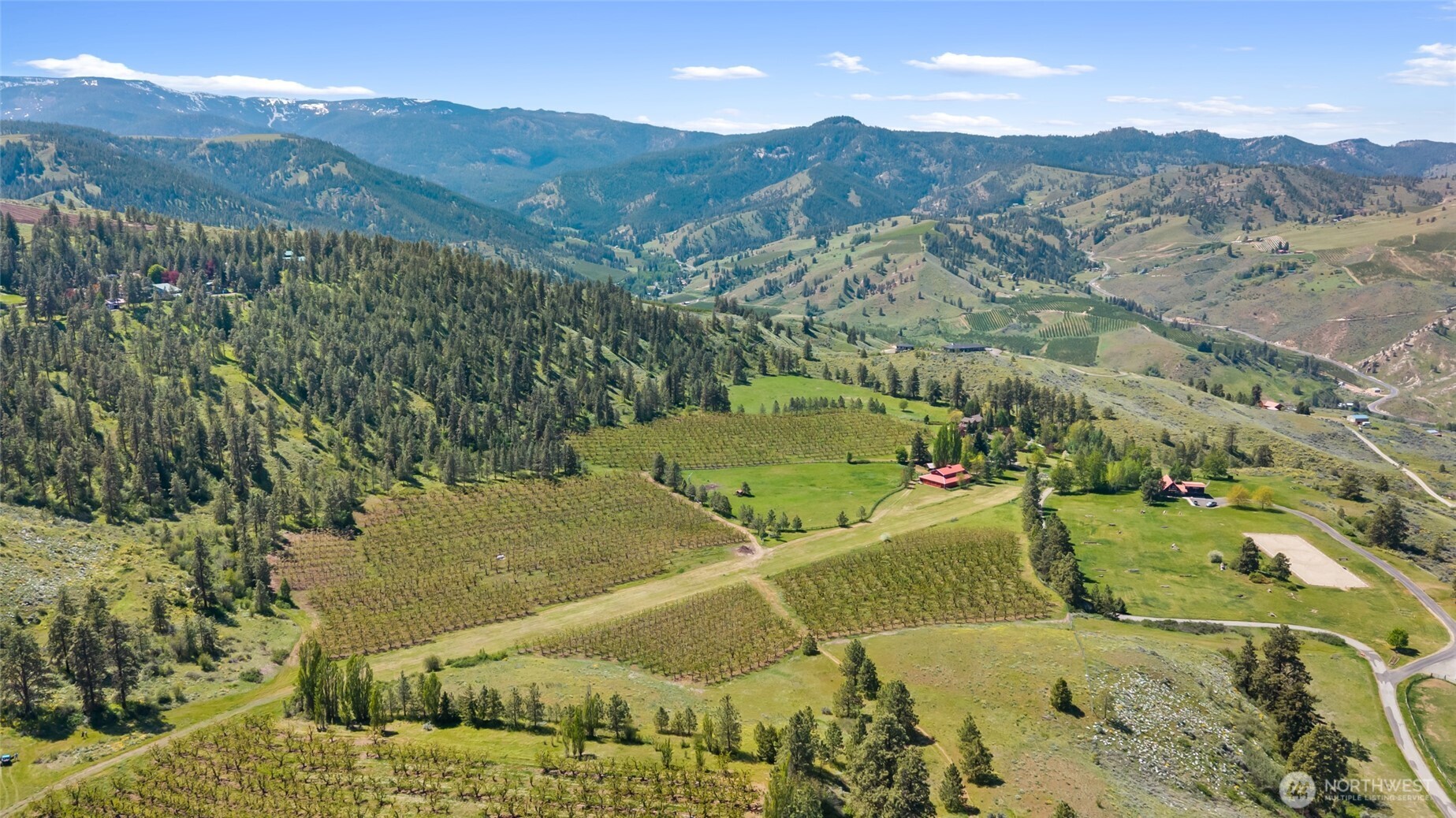 712 Moonlit Lane Wenatchee, WA 98801 - Photo 2 of 29 an aerial view of a forest with mountains