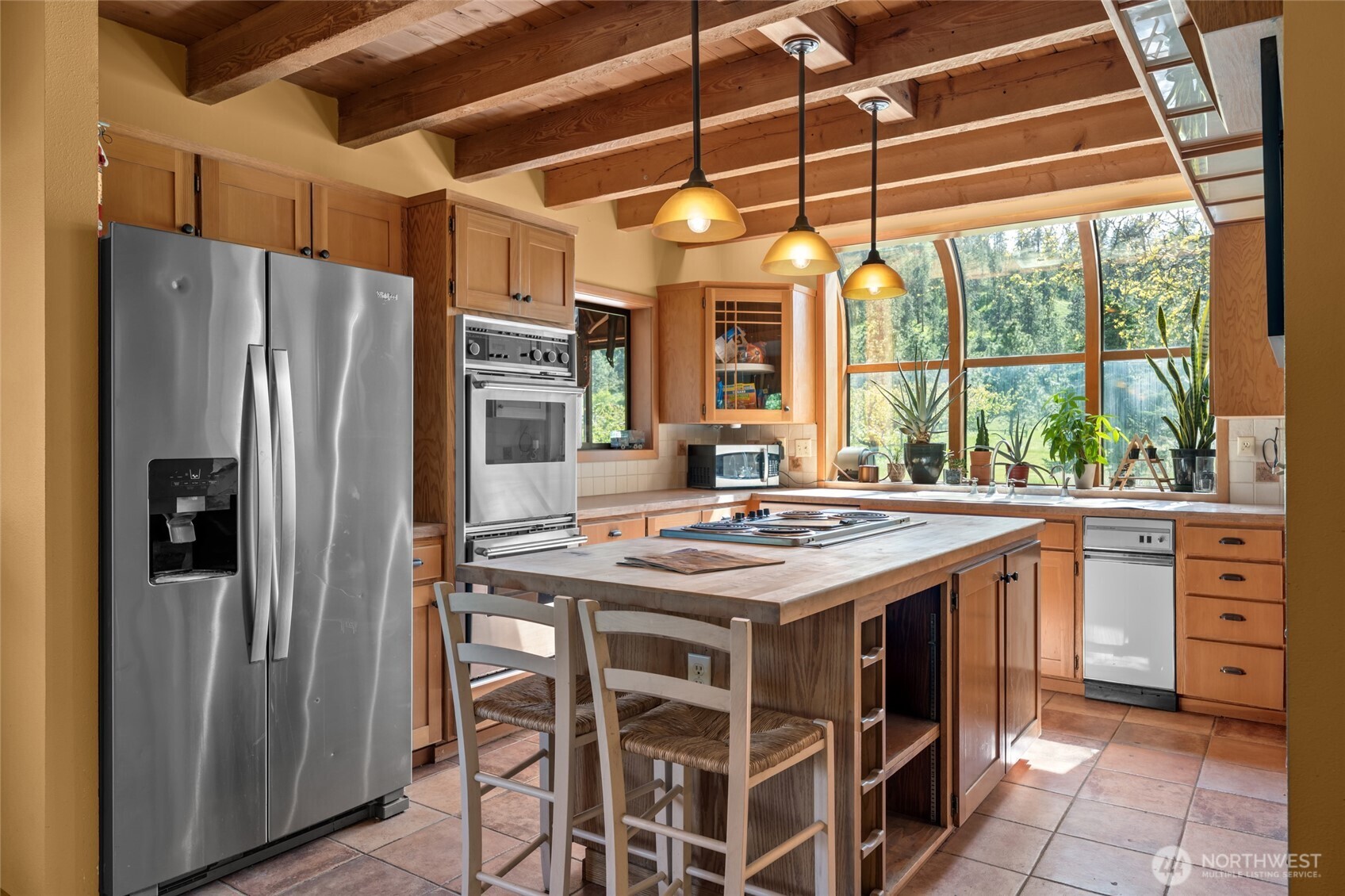 712 Moonlit Lane Wenatchee, WA 98801 - Photo 5 of 29 a kitchen with a stove a refrigerator and a stove top oven