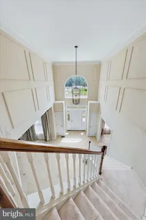 a view of a room with wooden floor and a bathroom